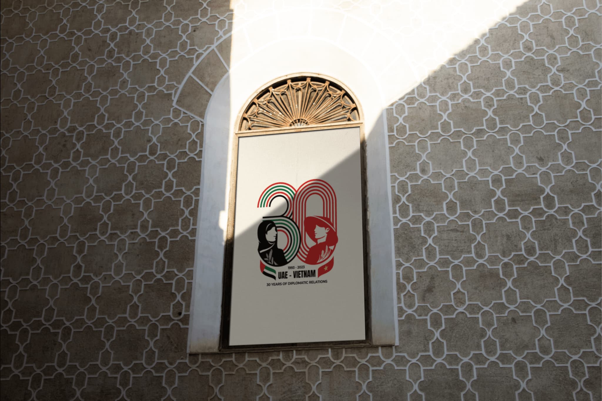Celebratory mural featuring "30" with black and red graphics, set against a patterned wall backdrop.