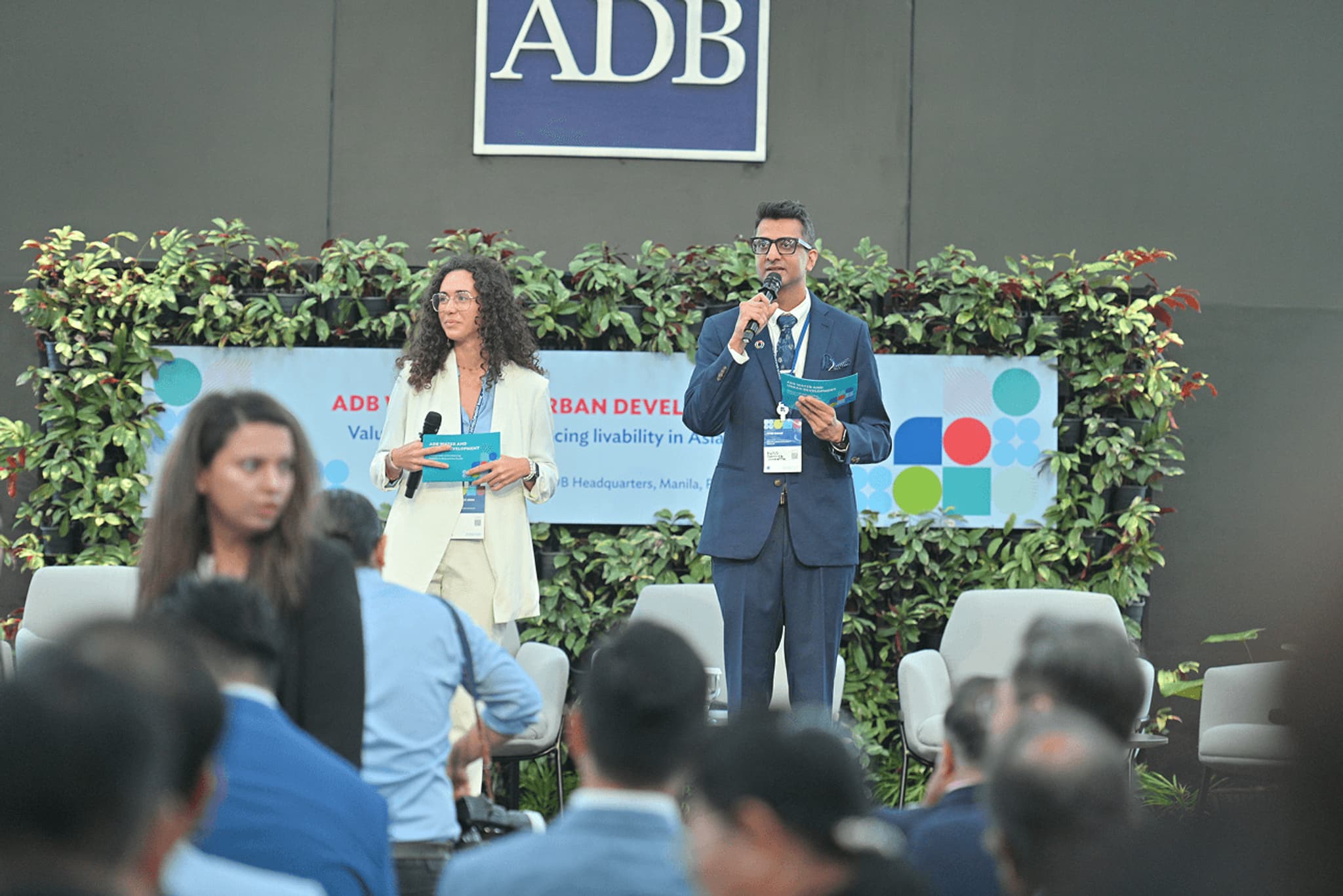 ADB Urban Development event with speakers presenting to an engaged audience, showcasing sustainability and inclusivity.