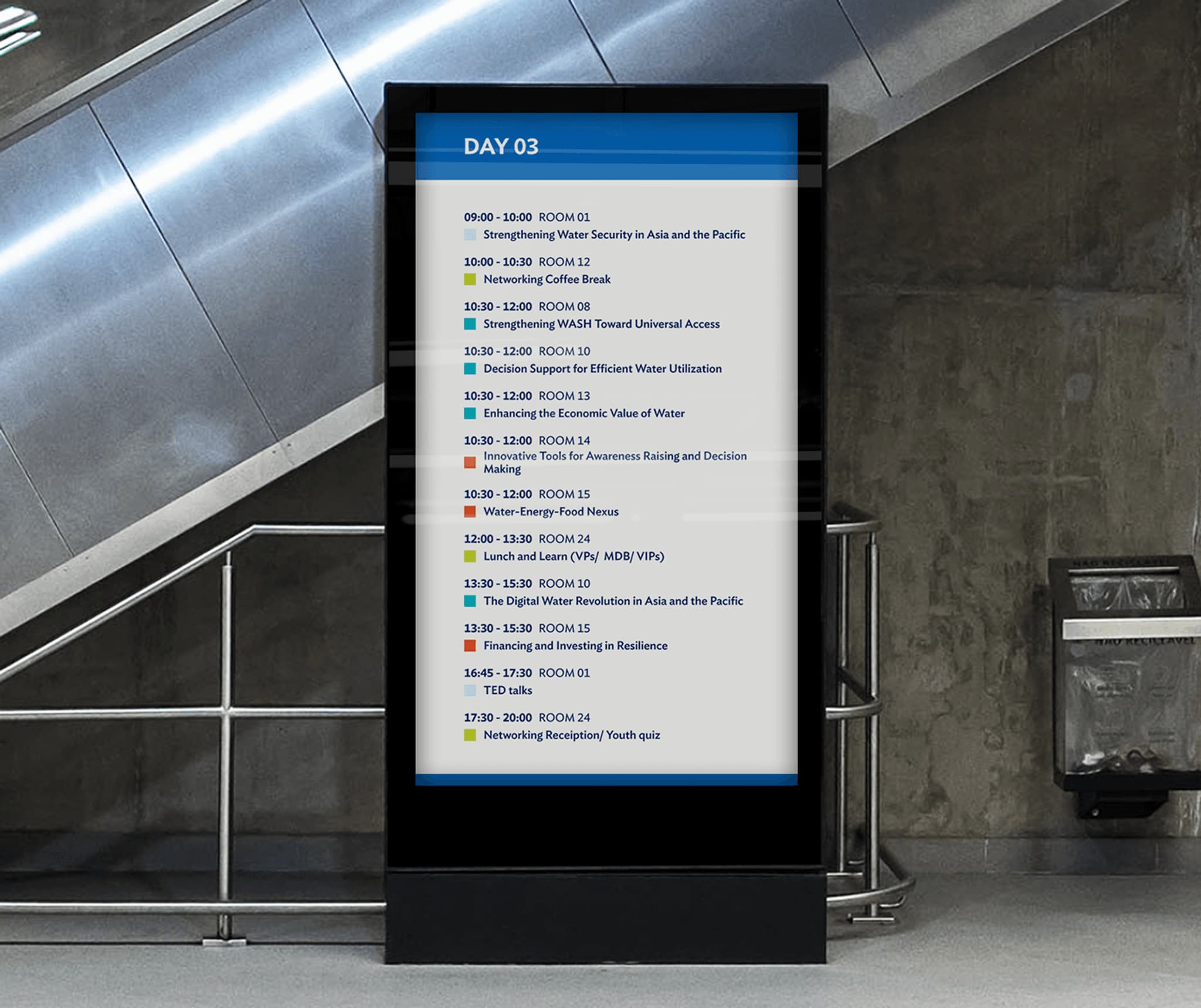 Wayfinding screen displaying event schedule for Day 03, including room assignments and session times.