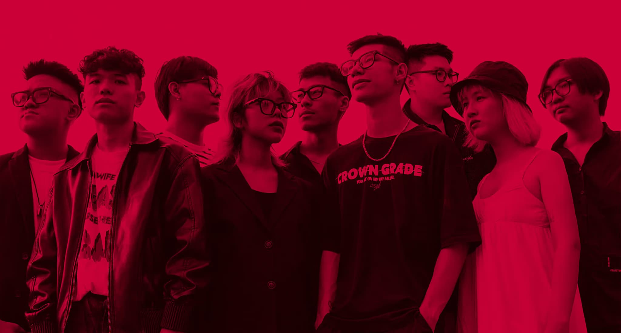 Group of diverse young individuals wearing glasses, posing against a vibrant red background, showcasing fashion and style.