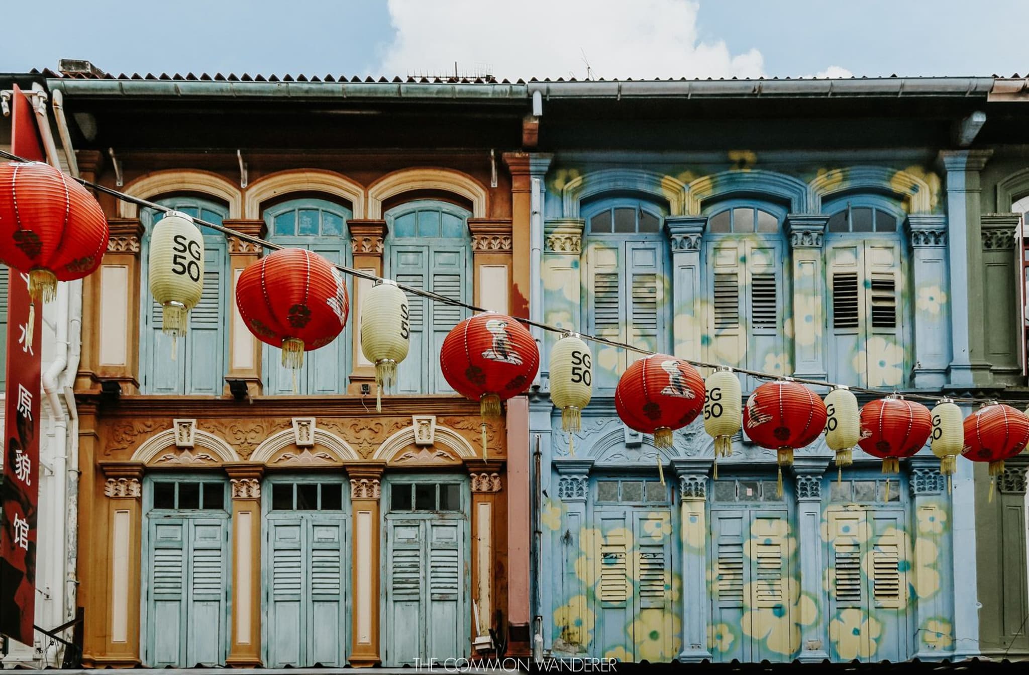 Colorful traditional architecture in Singapore with red lanterns and vibrant murals, showcasing heritage and cultural charm.