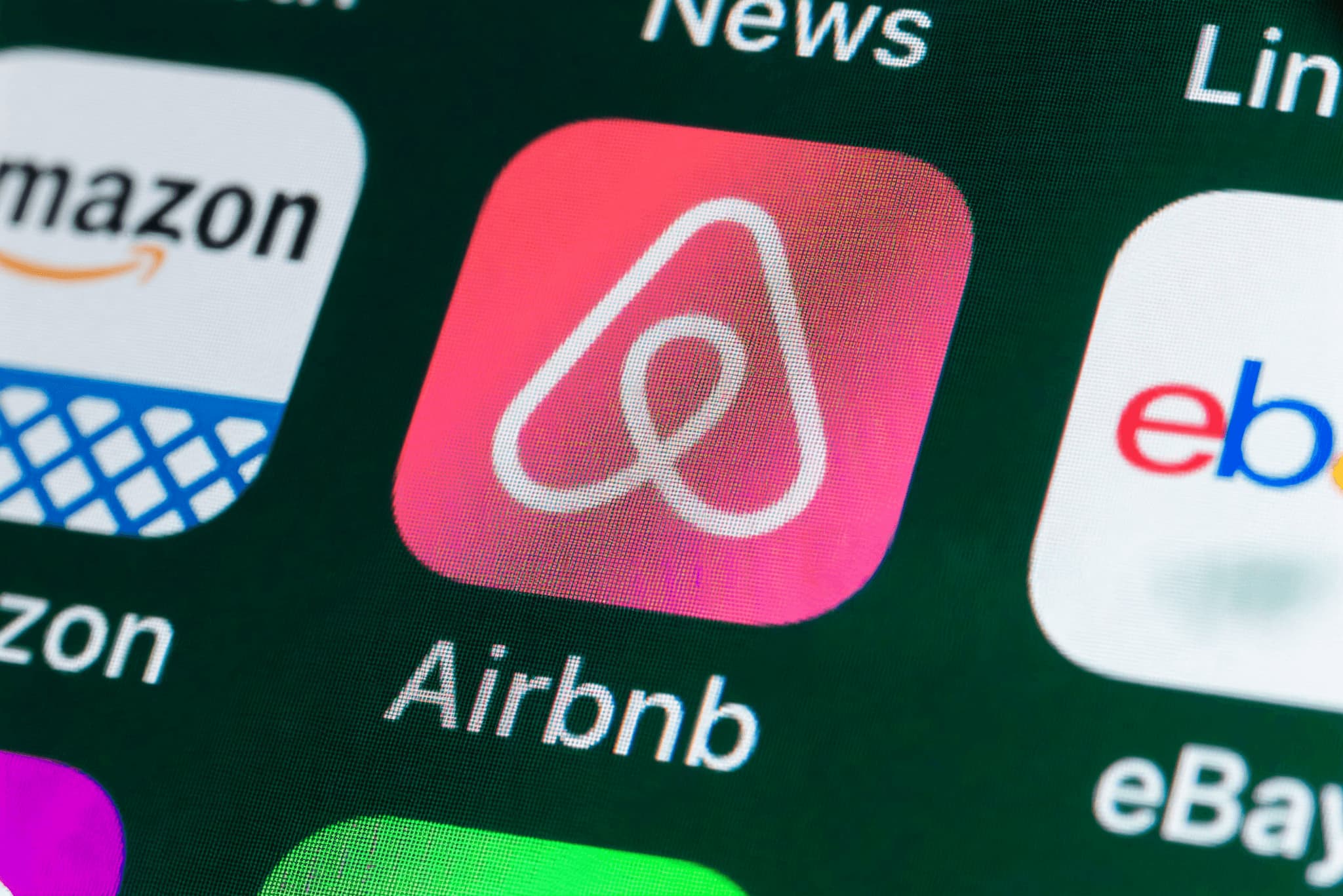 Airbnb app icon highlighted on a smartphone screen, showcasing brand recognition and digital accessibility.